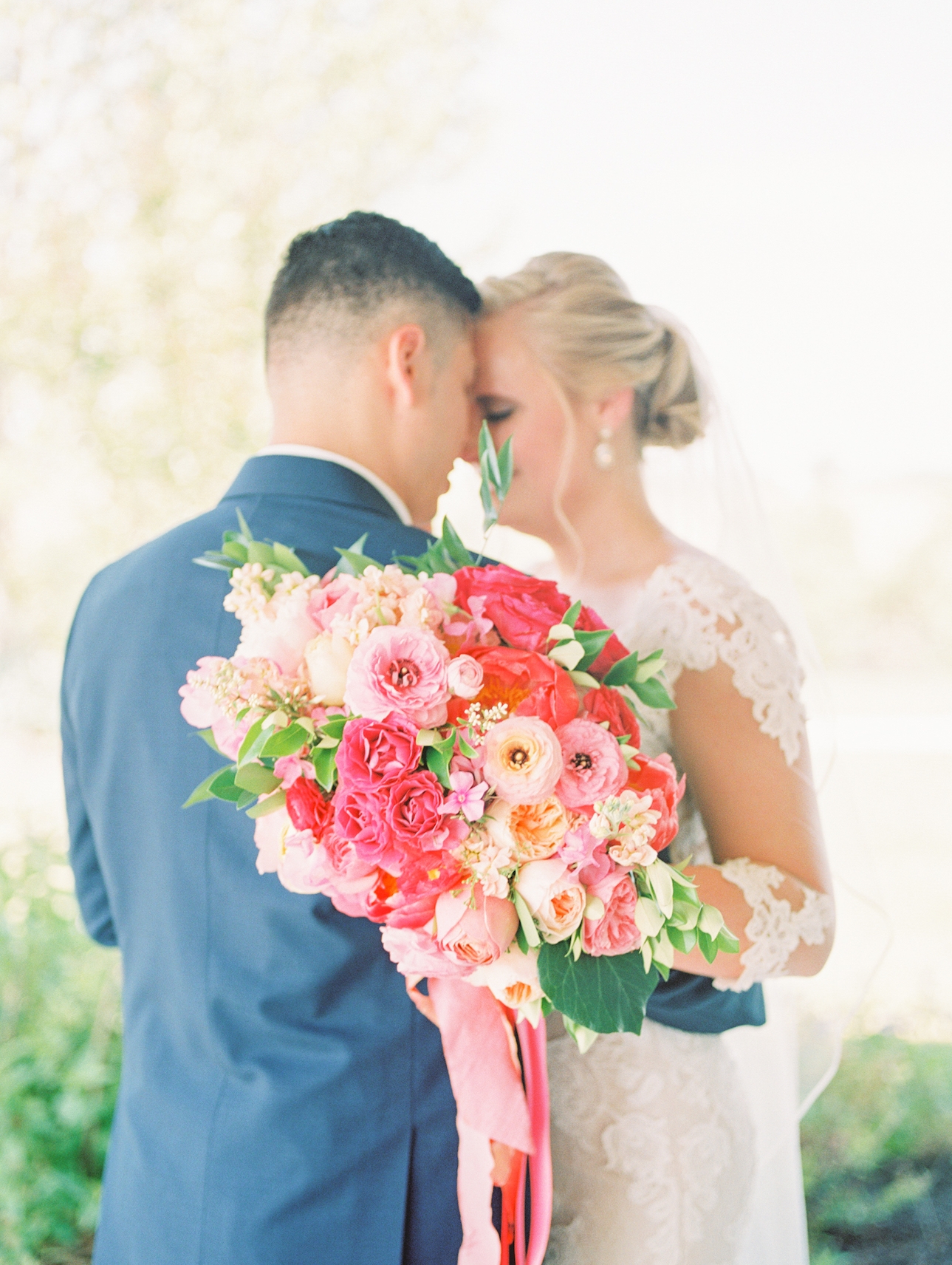 bride and groom with colorful bouquet