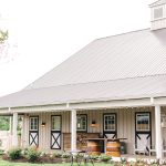 The exterior of Shadow Creek wedding venue in Virginia with a metal roof and rustic outdoor furniture under the overhang